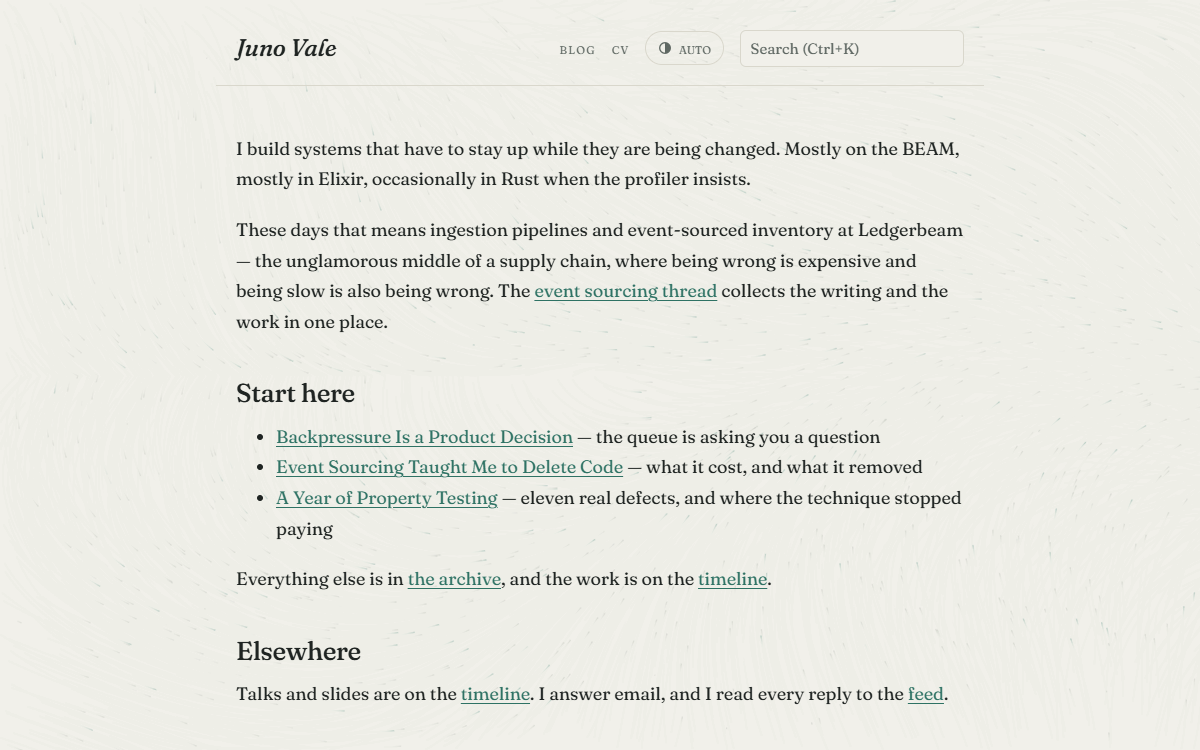 The erosion theme blog index: a two-column serif grid over a drifting grain field