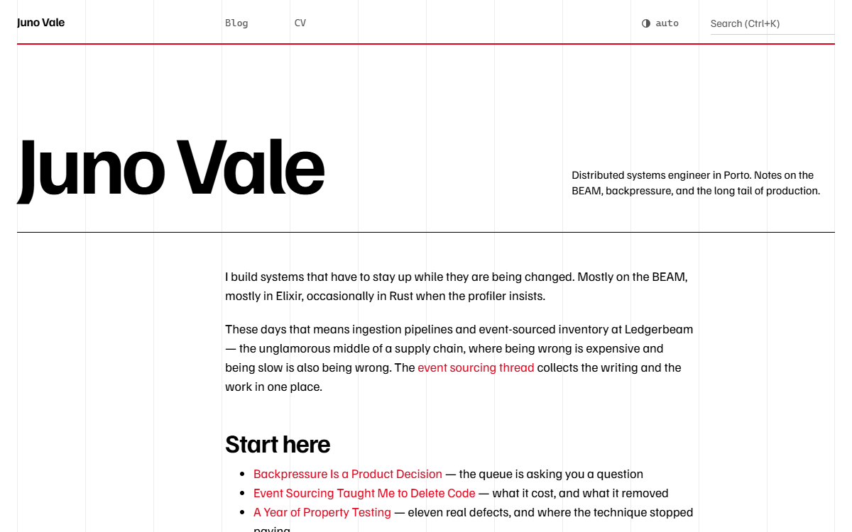 The swiss theme home page: a huge flush-left name on a visible twelve-column grid with red links